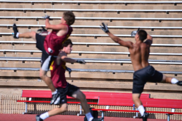 Even out of focus, it is clear that he is making the catch after leaping rather high and pulling it in with one hand. 