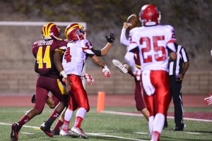 The ball has bounced off the white jersey with the 4 on it, the hand pulling it in is #8